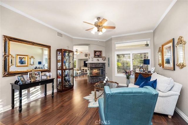 2157 Pecan Tree St, Hemet, CA 92545 - living area featuring a ceiling fan, dark wood finished floors, crown molding, a glass covered fireplace, and arched walkways