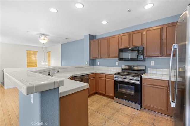 39635 Columbia Union Dr Unit C, Murrieta, CA 92563 - kitchen with appliances with stainless steel finishes, tile counters, a peninsula, recessed lighting, and brown cabinetry