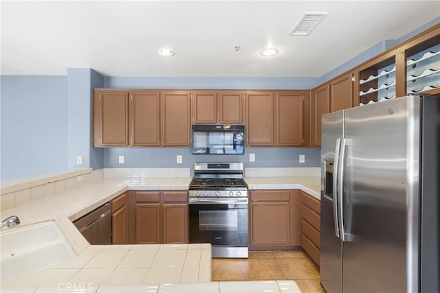 39635 Columbia Union Dr Unit C, Murrieta, CA 92563 - kitchen featuring stainless steel appliances, a peninsula, tile countertops, recessed lighting, and light tile patterned floors