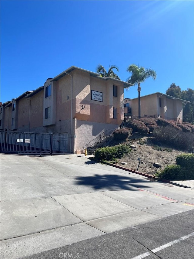 552 Canyon Dr Unit 38, Oceanside, CA 92054 - view of side of property with stucco siding and stairs