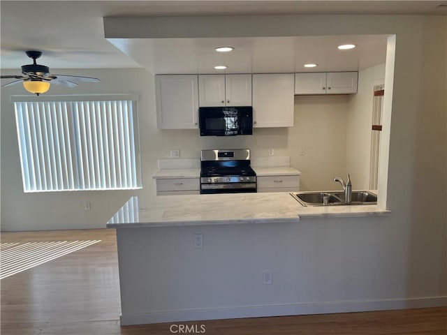552 Canyon Dr Unit 38, Oceanside, CA 92054 - kitchen featuring stainless steel range oven, black microwave, ceiling fan, white cabinets, and recessed lighting