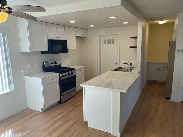552 Canyon Dr Unit 38, Oceanside, CA 92054 - kitchen with stainless steel range with gas cooktop, black microwave, light wood-type flooring, a peninsula, and recessed lighting