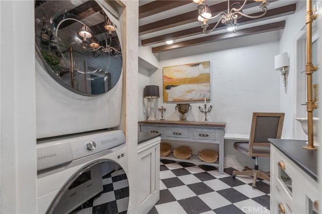 24042 Ingomar St, West Hills, CA 91304 - washroom with stacked washing machine and dryer, dark flooring, and a chandelier