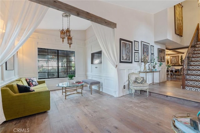24042 Ingomar St, West Hills, CA 91304 - living room featuring a decorative wall, stairs, hardwood / wood-style flooring, and a chandelier