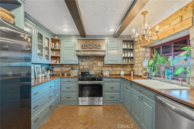 24042 Ingomar St, West Hills, CA 91304 - kitchen featuring stainless steel appliances, open shelves, brick patterned flooring, a chandelier, and beamed ceiling