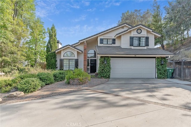 24042 Ingomar St, West Hills, CA 91304 - traditional-style house featuring a chimney, driveway, and an attached garage