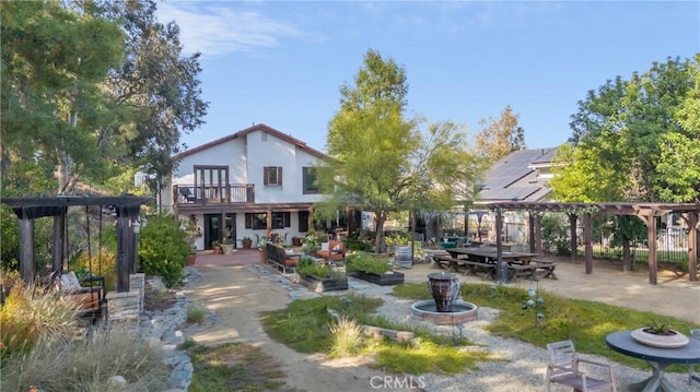 24042 Ingomar St, West Hills, CA 91304 - back of property featuring a pergola, a balcony, and a patio
