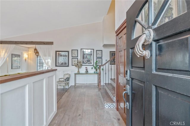 24042 Ingomar St, West Hills, CA 91304 - foyer entrance with stairs, light wood finished floors, and a wainscoted wall