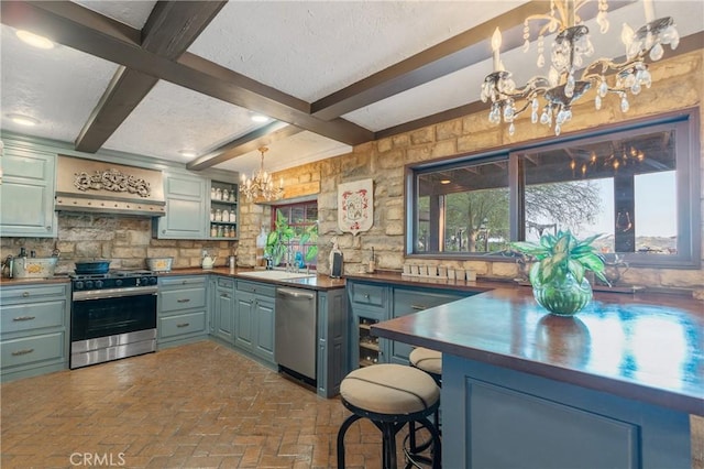 24042 Ingomar St, West Hills, CA 91304 - kitchen featuring a chandelier, stainless steel appliances, dark countertops, beamed ceiling, and plenty of natural light