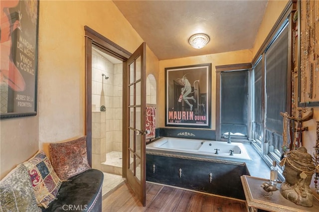 24042 Ingomar St, West Hills, CA 91304 - full bathroom featuring a garden tub, tiled shower, wood finished floors, and french doors