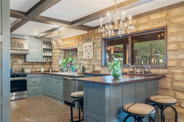 24042 Ingomar St, West Hills, CA 91304 - bar area featuring appliances with stainless steel finishes, a chandelier, beamed ceiling, brick floors, and pendant lighting