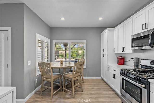 37152 57th St E, Palmdale, CA 93552 - kitchen with stainless steel appliances, light countertops, light wood finished floors, white cabinets, and recessed lighting