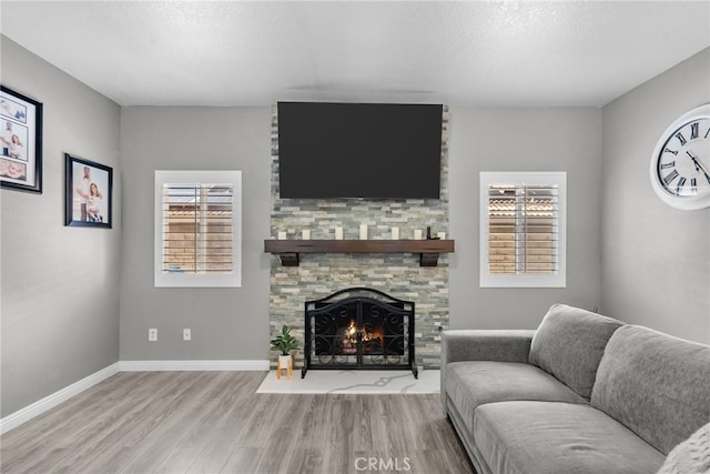 37152 57th St E, Palmdale, CA 93552 - living room with wood finished floors, plenty of natural light, a fireplace, and a textured ceiling