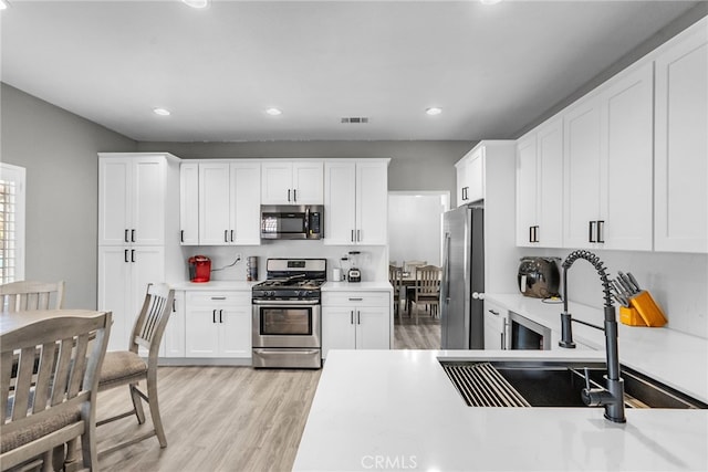 37152 57th St E, Palmdale, CA 93552 - kitchen with appliances with stainless steel finishes, light countertops, light wood finished floors, and recessed lighting