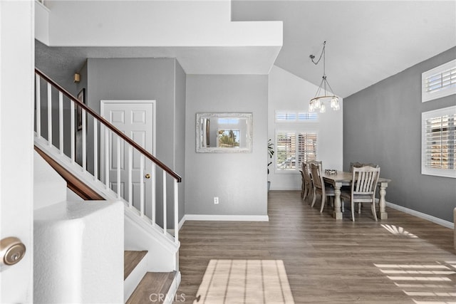 37152 57th St E, Palmdale, CA 93552 - dining area featuring stairway, wood finished floors, high vaulted ceiling, and a chandelier