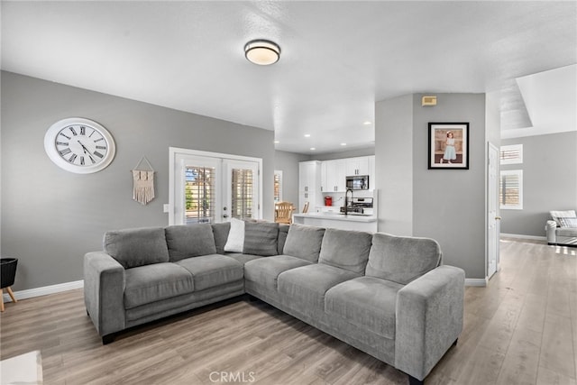 37152 57th St E, Palmdale, CA 93552 - living room featuring light wood-type flooring, recessed lighting, and french doors