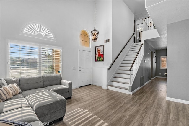 37152 57th St E, Palmdale, CA 93552 - living room featuring a towering ceiling, stairs, and wood finished floors