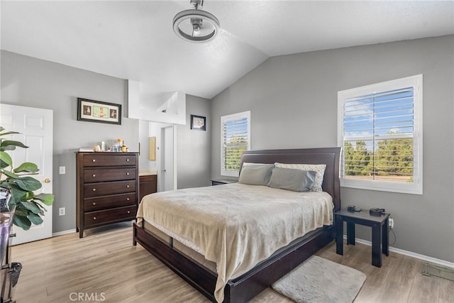 37152 57th St E, Palmdale, CA 93552 - bedroom with light wood-style flooring and vaulted ceiling