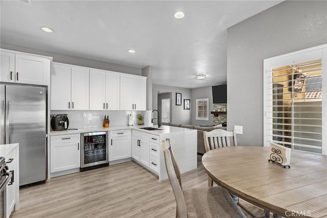 37152 57th St E, Palmdale, CA 93552 - kitchen featuring beverage cooler, freestanding refrigerator, white cabinets, light countertops, and recessed lighting