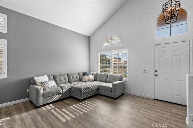37152 57th St E, Palmdale, CA 93552 - living room with high vaulted ceiling, wood finished floors, and a chandelier