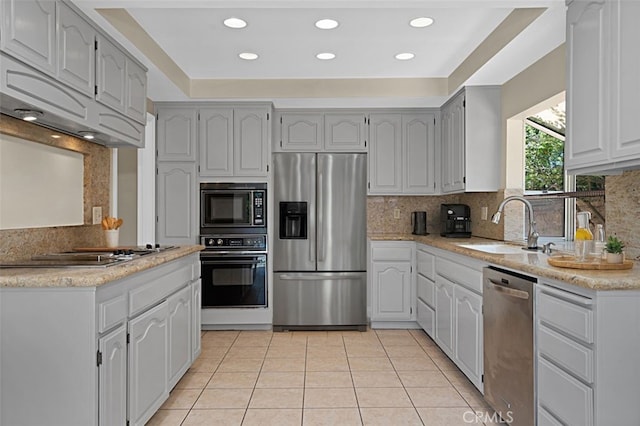 3386 Montagne Way, Thousand Oaks, CA 91362 - kitchen featuring black appliances, decorative backsplash, light tile patterned floors, recessed lighting, and a tray ceiling