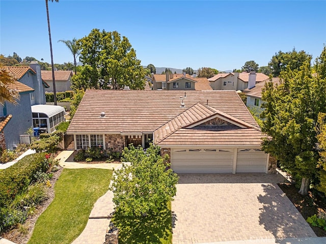 3386 Montagne Way, Thousand Oaks, CA 91362 - view of front of property featuring a tile roof, a residential view, stone siding, driveway, and an attached garage