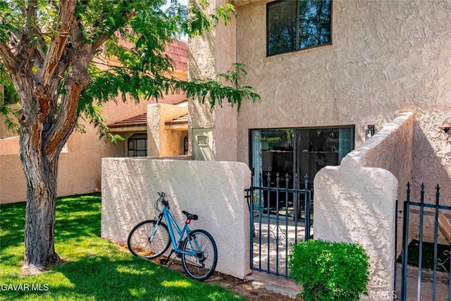 425 W W Ave J5, Unit 36, Lancaster, CA 93534 - rear view of house featuring a gate and stucco siding