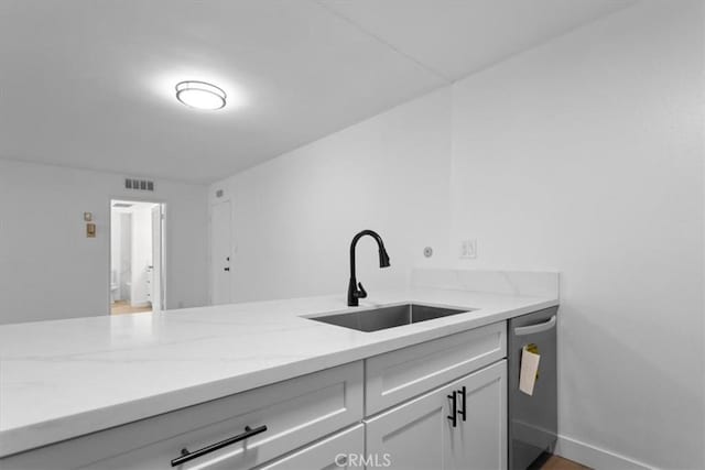 5403 Newcastle Ave Unit 19, Encino, CA 91316 - kitchen with dishwasher, light stone counters, and white cabinets