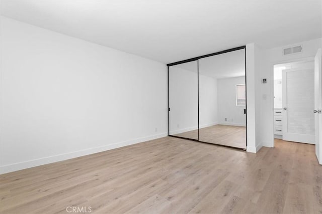 5403 Newcastle Ave Unit 19, Encino, CA 91316 - unfurnished bedroom with light wood finished floors and a closet