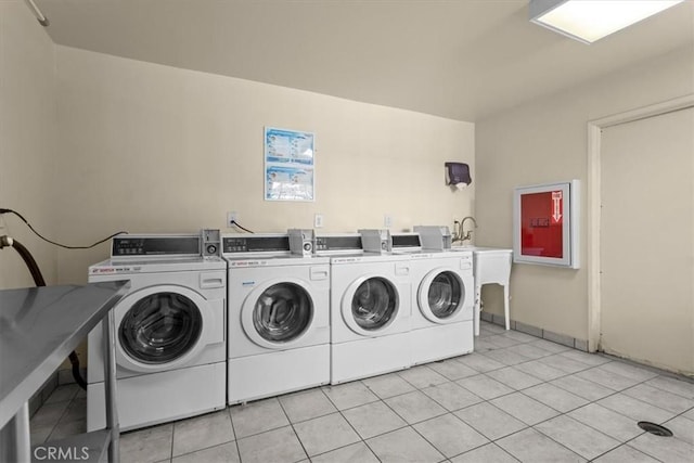 5403 Newcastle Ave Unit 19, Encino, CA 91316 - community laundry room with washing machine and dryer and light tile patterned floors