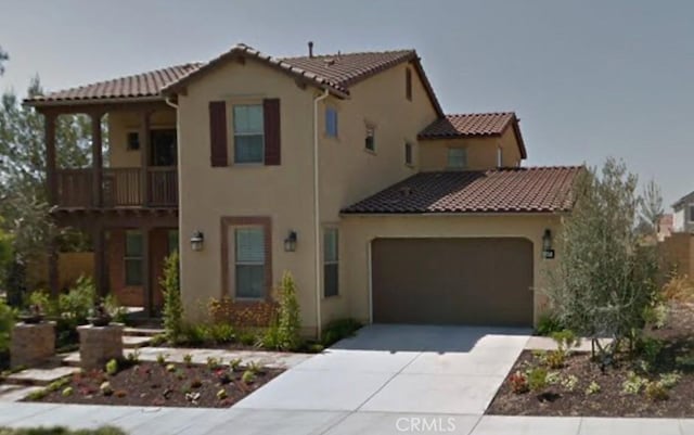 147 Yellow Daisy, Irvine, CA 92618 - mediterranean / spanish home featuring stucco siding, a tiled roof, concrete driveway, an attached garage, and a balcony