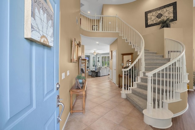 42207 Kimberly Way, Murrieta, CA 92562 - foyer entrance featuring stairway, a towering ceiling, light tile patterned floors, and ceiling fan