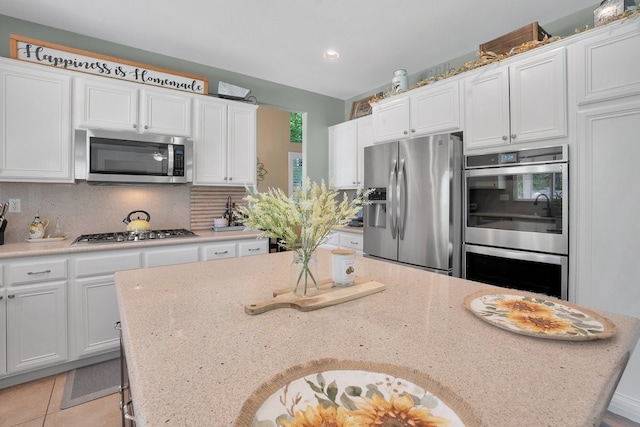 42207 Kimberly Way, Murrieta, CA 92562 - kitchen featuring stainless steel appliances, white cabinets, backsplash, recessed lighting, and light stone countertops