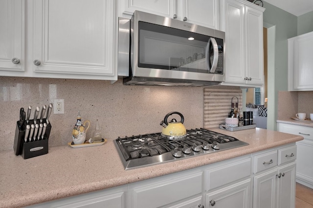 42207 Kimberly Way, Murrieta, CA 92562 - kitchen featuring appliances with stainless steel finishes, white cabinets, and backsplash