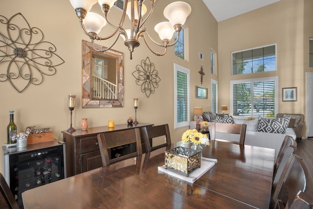 42207 Kimberly Way, Murrieta, CA 92562 - dining room with wine cooler, a chandelier, wood finished floors, and a high ceiling