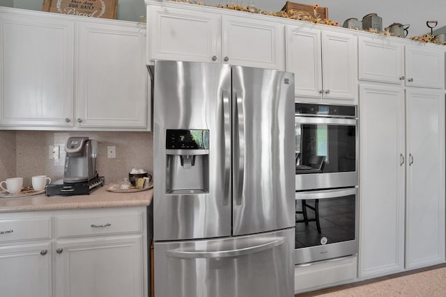 42207 Kimberly Way, Murrieta, CA 92562 - kitchen featuring appliances with stainless steel finishes, white cabinets, light countertops, and decorative backsplash