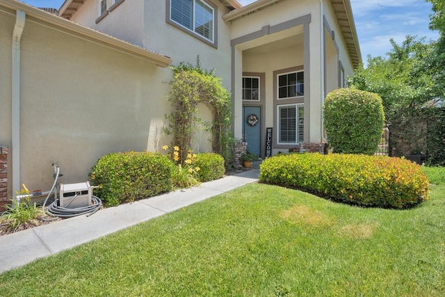 42207 Kimberly Way, Murrieta, CA 92562 - view of exterior entry featuring stucco siding and a lawn