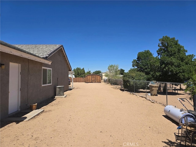 9294 Manteca Ave, Hesperia, CA 92345 - fenced backyard with a storage unit
