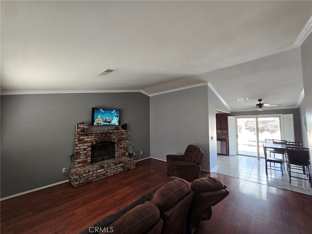 9294 Manteca Ave, Hesperia, CA 92345 - living room featuring wood finished floors, a fireplace, crown molding, a ceiling fan, and vaulted ceiling