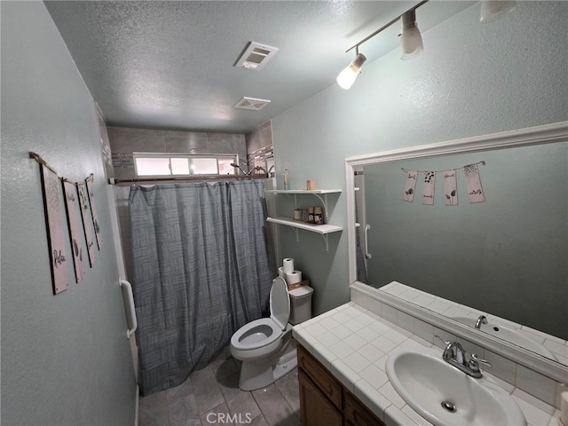 9294 Manteca Ave, Hesperia, CA 92345 - bathroom featuring vanity, a textured ceiling, a textured wall, and shower / tub combo with curtain
