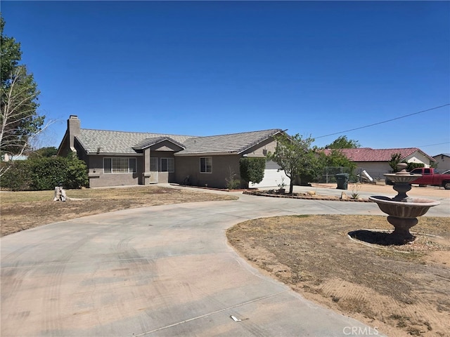 9294 Manteca Ave, Hesperia, CA 92345 - ranch-style home featuring curved driveway, stucco siding, a tile roof, and a chimney