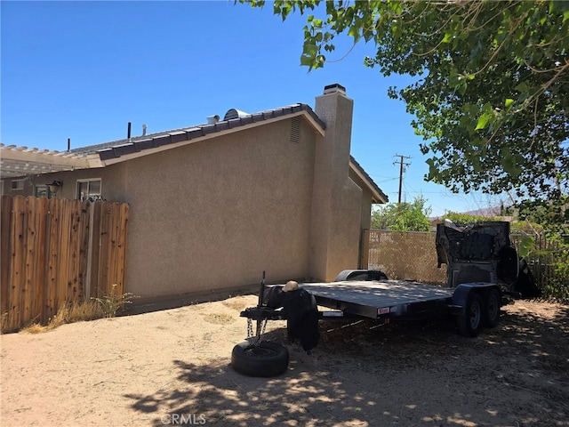 9294 Manteca Ave, Hesperia, CA 92345 - view of side of property featuring stucco siding and a chimney