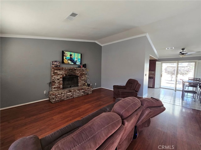 9294 Manteca Ave, Hesperia, CA 92345 - living room with crown molding, wood finished floors, ceiling fan, a brick fireplace, and vaulted ceiling
