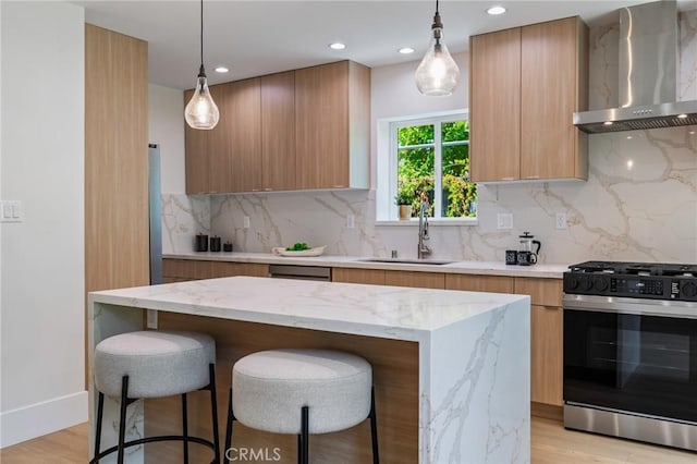 439 S Lamer St, Burbank, CA 91506 - kitchen featuring stainless steel appliances, wall chimney exhaust hood, modern cabinets, a breakfast bar, and a center island