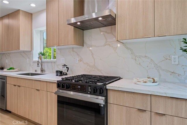 439 S Lamer St, Burbank, CA 91506 - kitchen with wall chimney range hood, gas range, light brown cabinetry, light stone counters, and recessed lighting