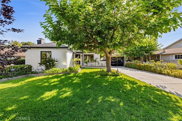 439 S Lamer St, Burbank, CA 91506 - view of front facade featuring a front yard, stucco siding, and a chimney