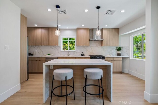 439 S Lamer St, Burbank, CA 91506 - kitchen with wall chimney range hood, modern cabinets, stainless steel appliances, a kitchen breakfast bar, and recessed lighting