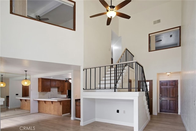 3350 M St Unit 33, Merced, CA 95348 - staircase featuring a high ceiling, a ceiling fan, and wood finished floors