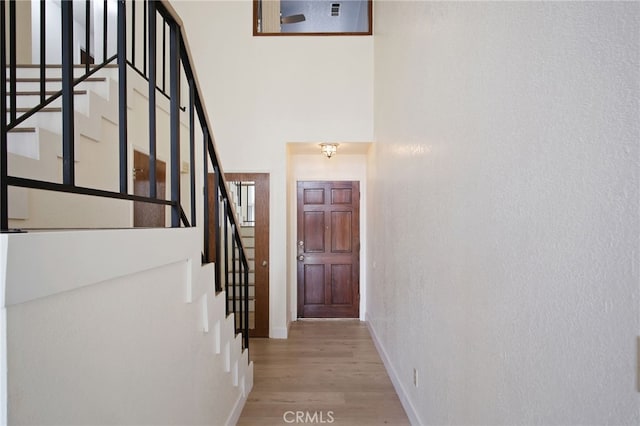3350 M St Unit 33, Merced, CA 95348 - corridor with wood finished floors, stairs, and a towering ceiling