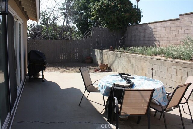 6400 Tournament Dr, Jurupa Valley, CA 92509 - fenced backyard featuring a patio, area for grilling, and outdoor dining area